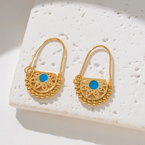 Macro view of 18K gold plated bohemian earrings with turquoise inlay and filigree work