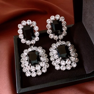 Detail of vintage square black stone drop earrings with sparkling rhinestone halo trim