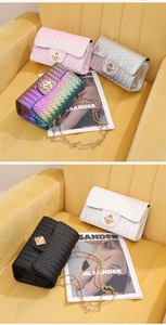 Detail of woven texture flap bag with golden diamond swivel lock and metal chain strap