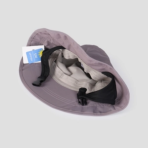 Detail of breathable mesh lining and UPF50+ sun protection tag on nylon sun hat