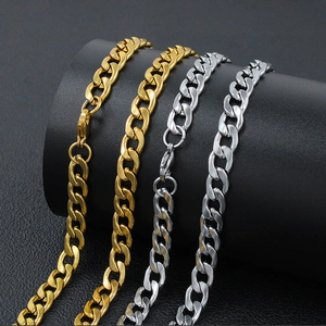 Detail of 4-8mm stainless steel Cuban link chains in gold and silver finish on leather