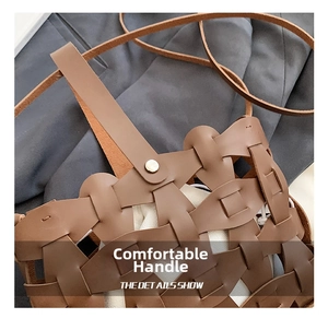 Detail of brown woven faux leather bag featuring sturdy handle and silver rivet reinforcement