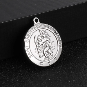 Detail of silver Saint Christopher round pendant with engraved protect us text