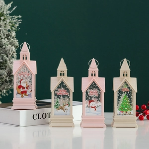 Christmas lantern ornaments with Santa and reindeer patterns on a festive white table