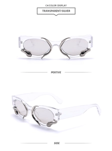 Detail of transparent sunglasses featuring silver liquid metal snake accents and grey lenses