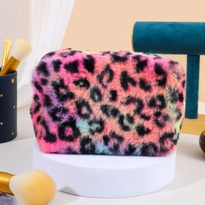 Plush leopard print makeup bag with colorful spots on a minimalist circular display