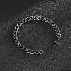 Detail of silver stainless steel Cuban link chain with a metal lobster clasp closure