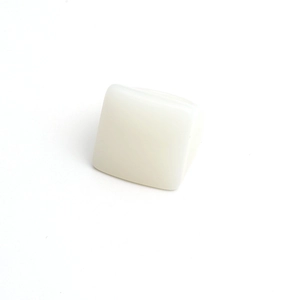 Close-up of a white square resin ring with translucent texture in a minimalist style