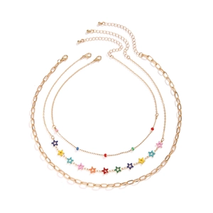 Three-piece layered gold necklace set with colorful star charms and enamel beads