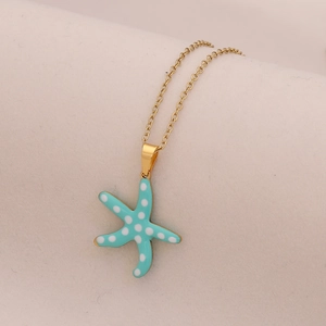 Blue starfish pendant necklace with white dots on a gold stainless steel chain