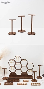 Macro detail of walnut wood jewelry stand set with T-shaped hangers and honeycomb rack