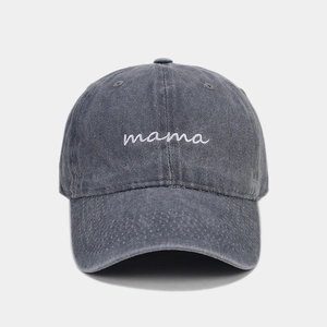 Close-up of white mama embroidery on dark gray washed cotton baseball cap