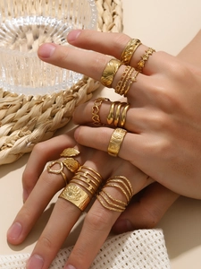 Close-up of bohemian style 18k gold plated ring set with snake and heart designs