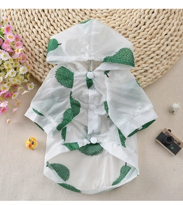Detail of thin white pet sun protection shirt with green pear patterns and buttons