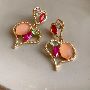 Vintage gold heart earrings with multi-colored gemstones in an ornate palace style