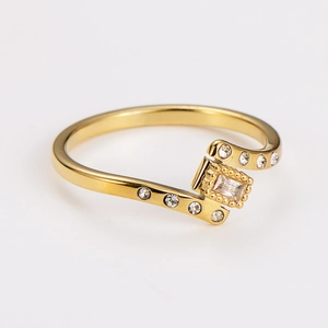 Detailed close-up of gold geometric ring with small pavé crystals and rectangle zircon