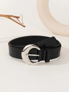 Detail of black crocodile texture belt with unique silver crescent metal buckle