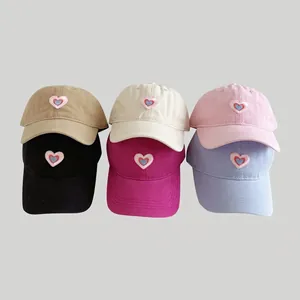 Collection of six washed cotton baseball caps with heart embroidery in diverse colors