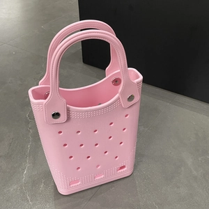 Detailed top view of a pink waterproof EVA beach bag with signature cutout holes