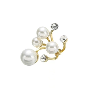 Elegant gold irregular open ring with pearls and zircon crystals on a white background