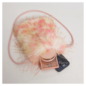 Detail view of white faux fur crossbody bag showing capacity for phone and cosmetics