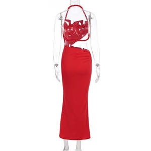 Detail of red halter dress featuring braided rope straps and side waist cut-out accents