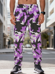 Detail of purple camouflage cargo pants featuring adjustable drawstring and elastic cuffs