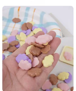 Close-up of colorful Angele mini cloud resin charms for DIY slime and crafts