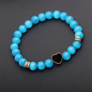 Blue cat eye bead bracelet with black heart pendant on black leather background