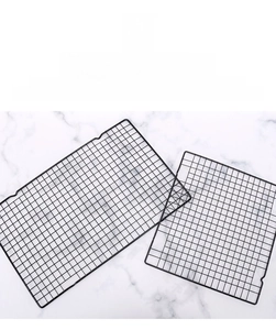 Detail of black non-stick carbon steel cooling rack with rectangular grid pattern
