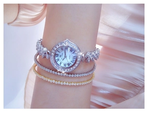 Close-up of luxury silver quartz watch with rhinestone bezel and matching bracelets