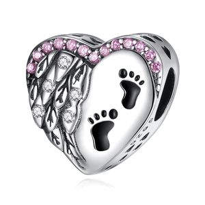 Macro shot of silver heart charm with pink stones, paw print, and S925 engraving