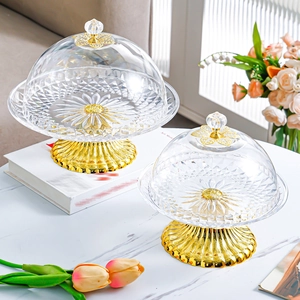 Detail of elegant gold-base cake stands with diamond-textured lids in two sizes