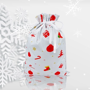 Detailed view of Christmas drawstring gift bag with festive trees and snowflake patterns