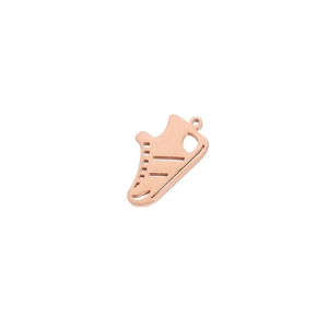 Macro shot of rose gold sneaker shaped pendant with a polished mirror finish surface