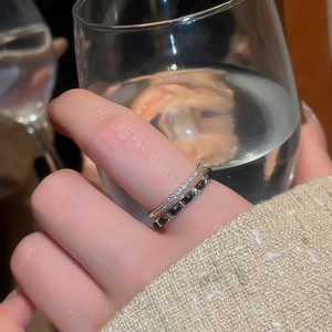 Detail of 14k gold plated stackable ring set with cubic zirconia and black chain design