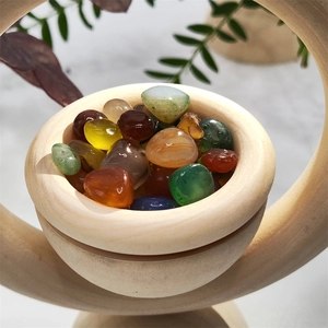 Macro shot of colorful polished crystals in a natural wooden essential oil diffuser bowl