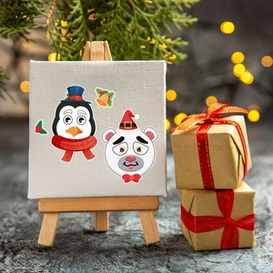 Mini Christmas canvas with penguin and polar bear on a wooden easel with gift boxes
