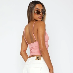 Detail of pink backless camisole featuring thin straps and pleated back design