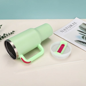 Close-up of a 40oz light green insulated tumbler with a handle and transparent straw