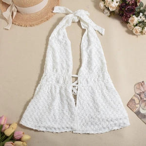 Detail of white textured halter top with cross-lace front tie for summer vacations