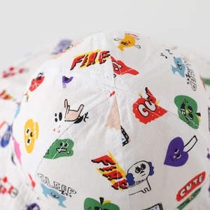 Detailed close-up of cartoon pattern print and stitching on white cotton sun hat