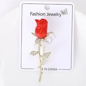 Macro shot of luxury red rose brooch with inlaid diamonds on high-quality silver alloy