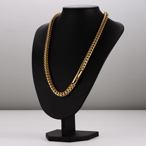 Mens hip hop gold braided stainless steel chain necklace on a black jewelry stand