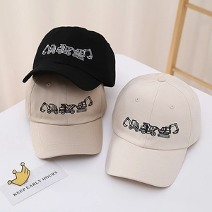 Kids baseball caps in black and khaki with detailed construction vehicle embroidery