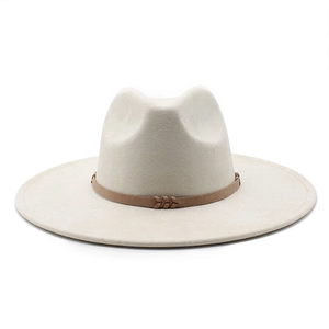 Close-up of beige suede fedora featuring a brown leather band with V-weave detail