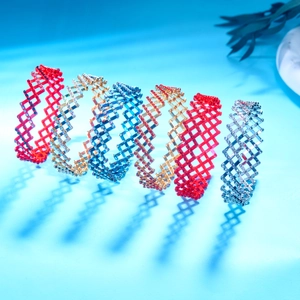 Macro detail of multi-row diamond-set magic telescopic rings in various metallic colors