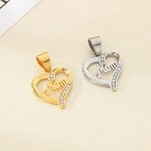 Macro shot of gold and silver heart Mom pendants with white zirconia stone settings