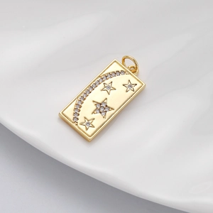 Detail of gold rectangular pendant with moon, star motifs and inlaid zircon crystals