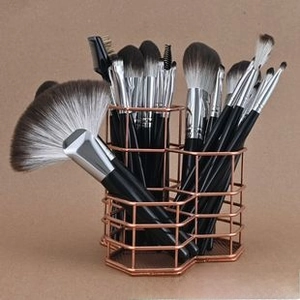 Rose gold metal makeup brush holder with a triple hexagonal honeycomb mesh structure